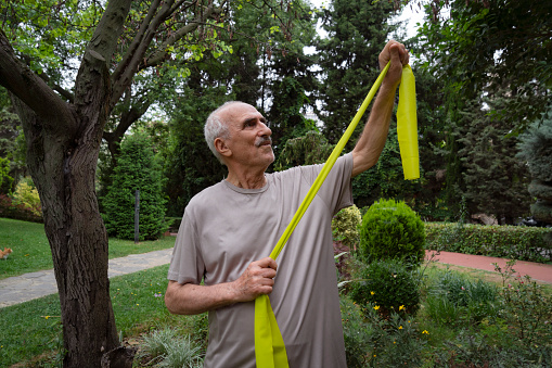 Senior man doing stretching in the public park at the morning