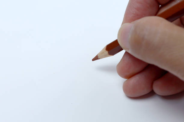 istock The right hand is drawing with pencil color. Isolated on white background. 1500340964