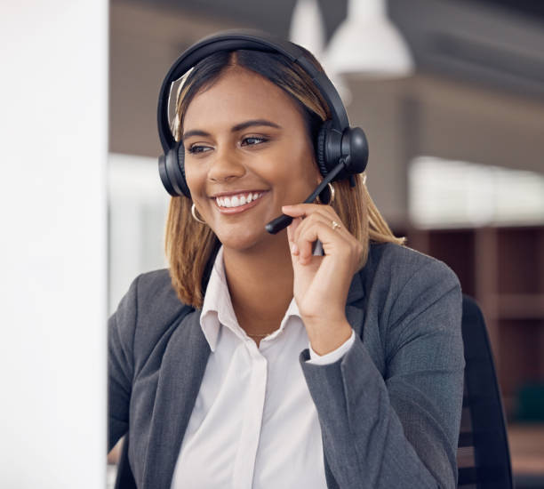 istock Call center, indian woman and smile at office computer in business, microphone and tech support and happiness. Telemarketing consultant, desktop pc and female crm with communication for customer care 1500341407