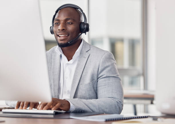 istock Call center, man and computer for typing with smile, reading and tech support with happiness at job. African telemarketing consultant, desktop pc and writing email for communication in customer care 1500341411