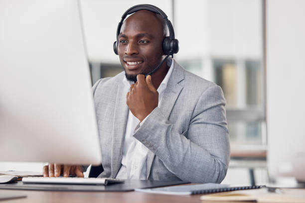 istock Black man, call center and computer with headset for telemarketing, customer service or support at office desk. Happy African American male consultant agent smiling with headphones on PC for advice 1500341413