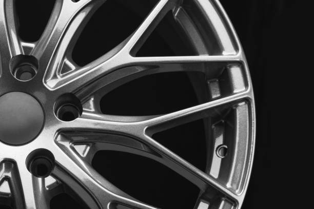 istock Beautiful gray aluminum disc cast wheel close-up on a black background, details. 1500342425