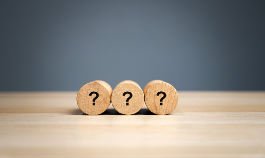 Wooden blocks with a question mark. Asking questions, searching for truth. Riddle mystery, investigation and research. FAQ - frequently asked questions. Search for information. Q&A