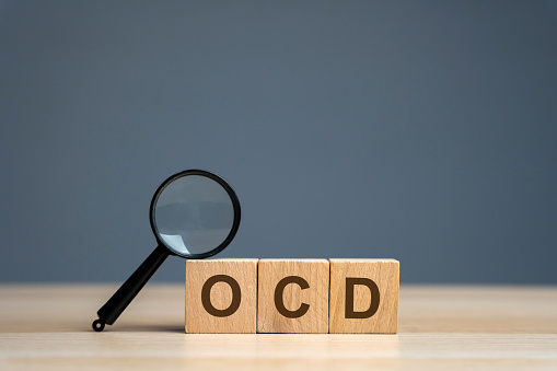 Wooden blocks with the abbreviation OCD. Obsessive compulsive disease. Mental health and psychiatry concept