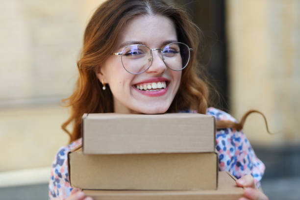 istock Happy woman holding purchases or parcels in her hands. 1500343554