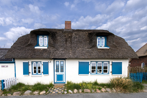 Germany, Nordstrand, April 22 2023, Typical thatched roof house in Nordfriesland on the Nordstrand peninsula, used as a holiday home