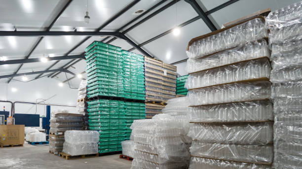 empty plastic bottles stacked inside a water bottling plant warehouse - plastic chemical warehouse industry imagens e fotografias de stock