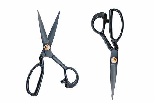 Large black scissors, two pairs, one opened, one closed, isolated on white background. Craft tools collection.