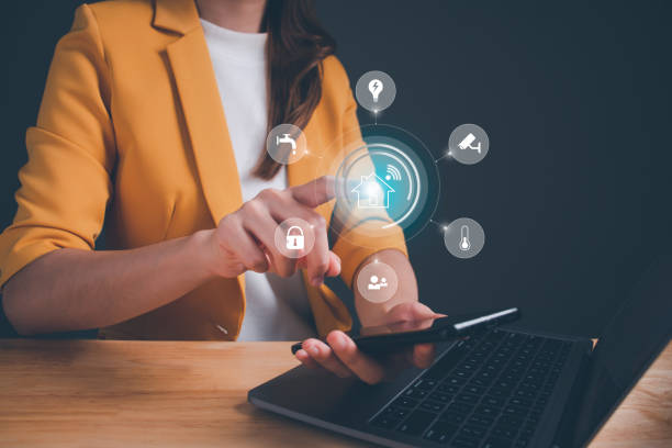 istock Circular futuristic interface on smartphone app of smart home automation assistant on virtual screen. Woman touching a home button. Smart living with technology. Efficiency security house. 1500353780