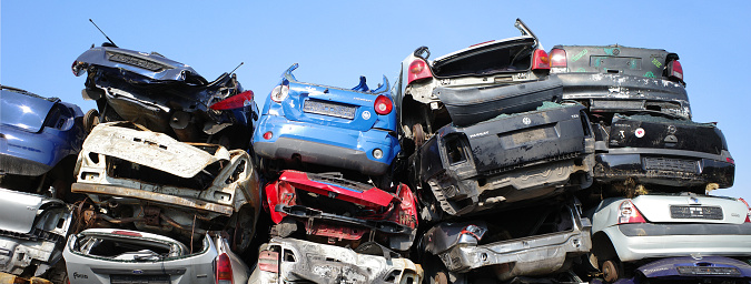 Neulehe, Germany - June 18 2023 Stacked cars on the grounds of a car scrap yard. This has specialized in the recycling of usable car parts