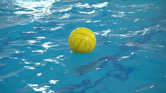 Water polo ball floats on the surface of the water in the pool