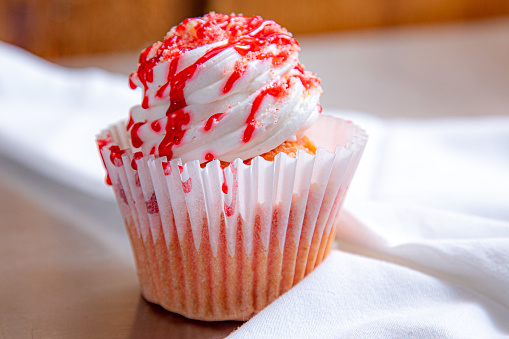 Sweet red velvet cupcake isolated on white