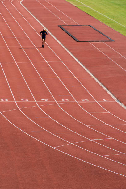 istock High angle view of men running on running track at stadium 1500356622