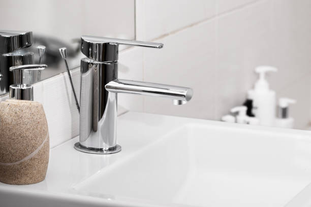 istock Sink and faucet in modern white bathroom. 1500357394