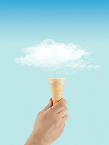 Cloud and ice cream cone in front of a blue sky