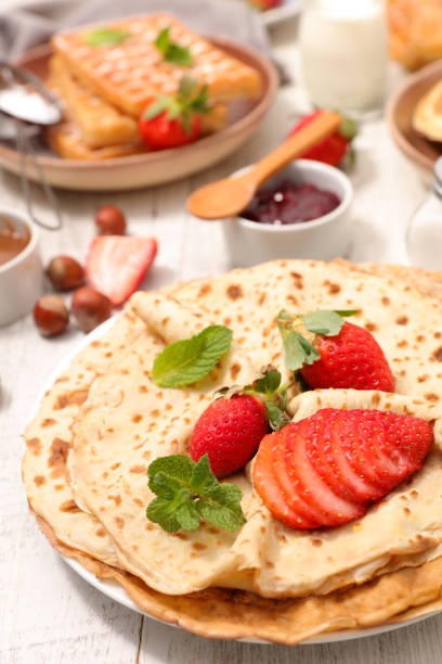 Fake strawberry cream waffle props model displayed on white plate in cafe refrigerator