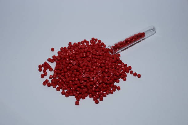 istock Red of plastic polymer granules on white background. 1500369279