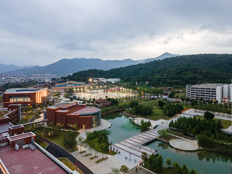Side bird's-eye view of campus buildings and artificial lakes