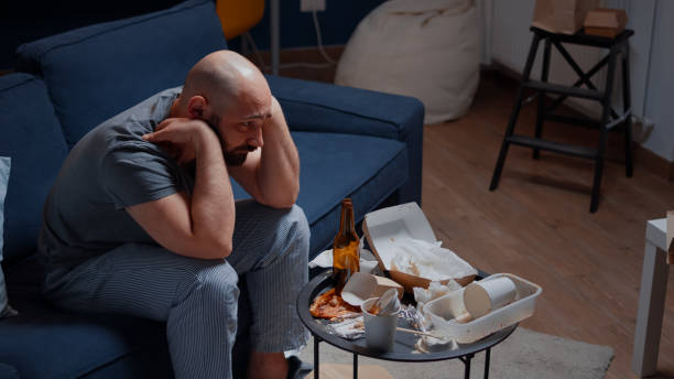 istock Psychotic alone depressed man sitting in sofa feeling disappointed 1500374639