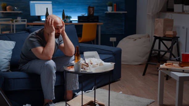 istock Exhausted frustrated depressed young man massaging temples 1500375403