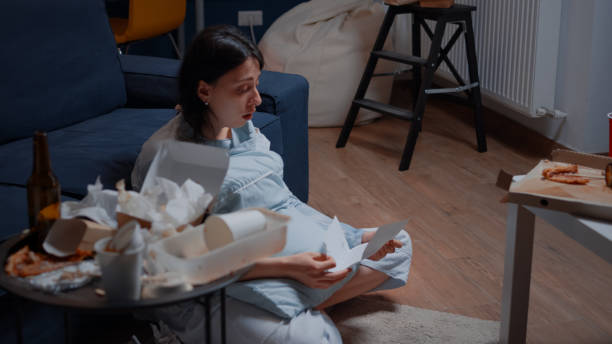 istock Devastated young woman crying reading letter debt notification 1500376187