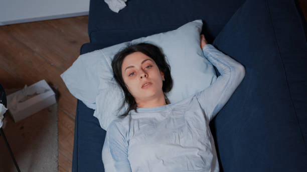 istock Depressed young woman sitting alone crying lying on sofa 1500376304
