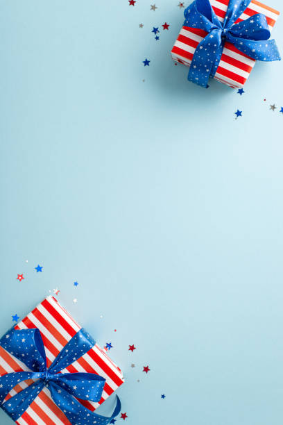 istock Independence Day festivity setup: Overhead vertical view of party essentials confetti, gift boxes in national flag colors. Placed against pastel blue background with empty space for text or advert 1500378323