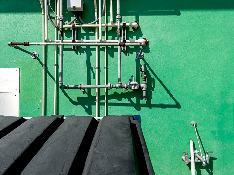 Close up tubes on exterior of industrial building wall