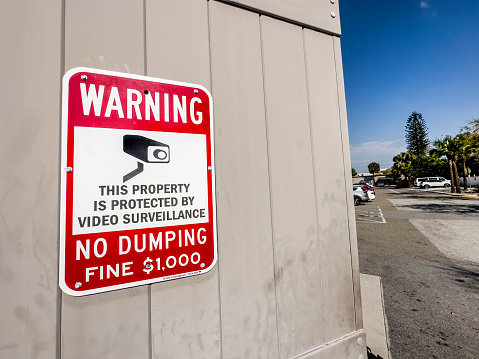 No dumping warning sign on building exterior