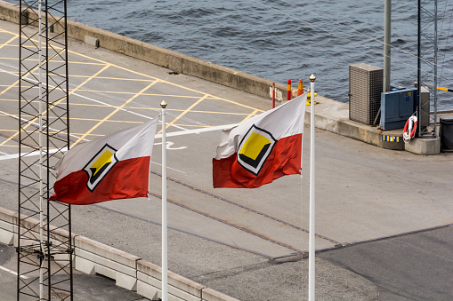 A photograph of the two flags with the vikingline logo on them