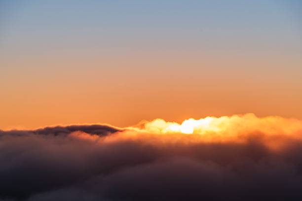 istock some clouds a sunset and some trees and mountains in the background 1500381527