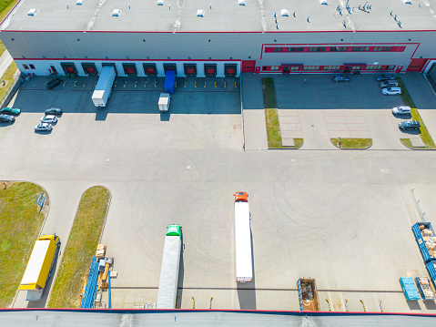 Aerial view of distribution center, drone photo of industrial logistics zone,new super modern logistics center full of modern technology and robotics,roof solar power plant for green energy production