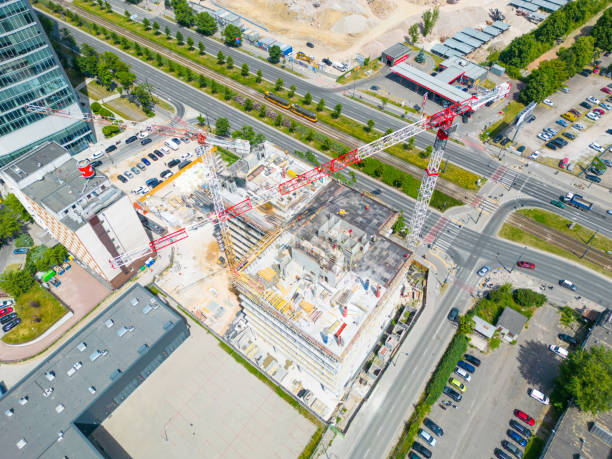 istock new residential district under construction. construction site with yellow tower cranes and machinery. aerial top view. City center 1500383264
