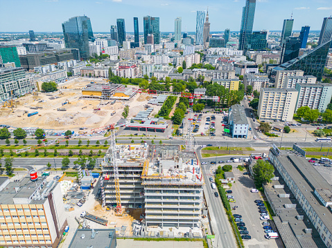 new residential district under construction. construction site with yellow tower cranes and machinery. aerial top view. City center