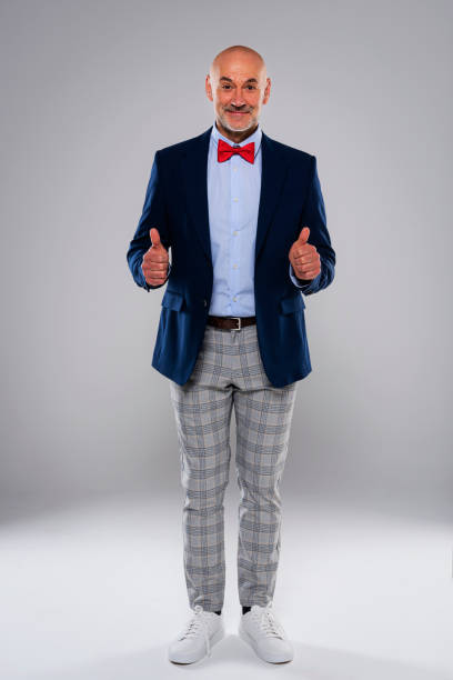 istock Happy man giving thumbs up at isolated grey background 1500388720