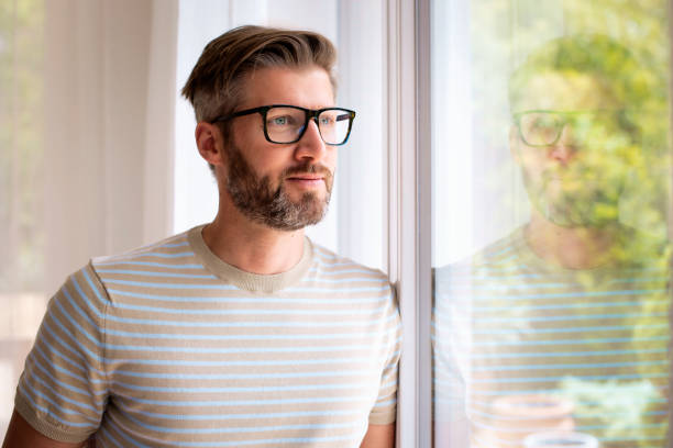 istock Mid aged man close-up portrait at the window 1500392845