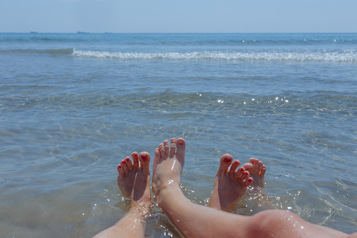 Female legs on the beach, summer time concept