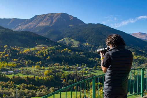 Artvin, Turkey, Photo taken on 15th October 2019: Man taking photos to autumn landscape with professional camera