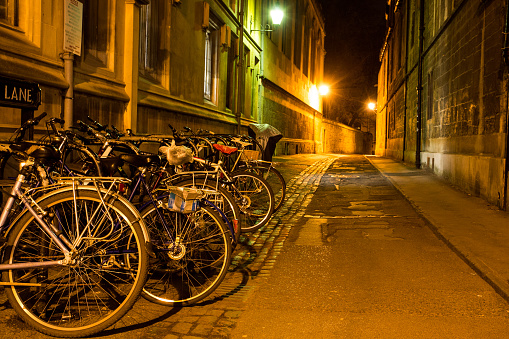 A row of bicycles at night on Brasenose Lane, Oxford.