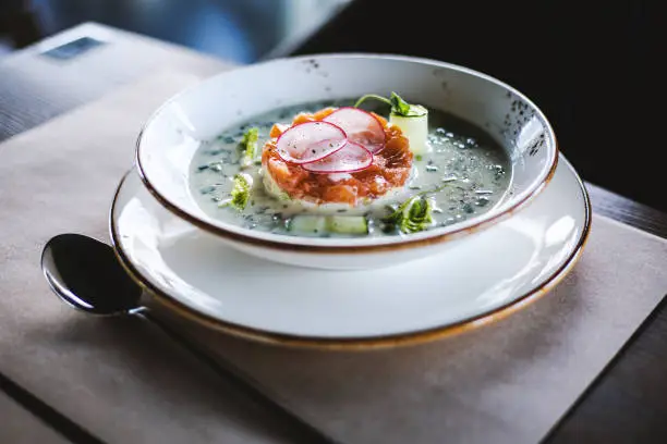 plate with cold soup with salmon