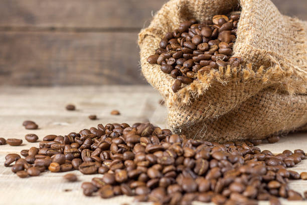istock Coffee beans on a wooden background. Copy space. Banner 1500400322