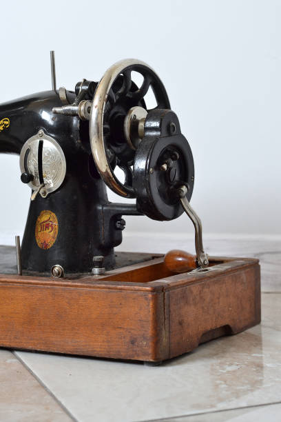 istock an old black sewing machine on a wooden stand 1500402769