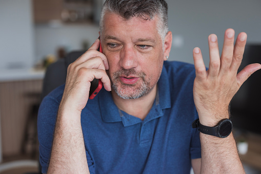 Close-up of a nervous businessman having a phone conversation
