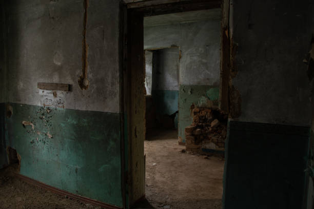 istock old abandoned one-story building dark without windows and doors, destroyed building 1500404429