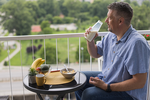 Man drinking milk directly from the bottle