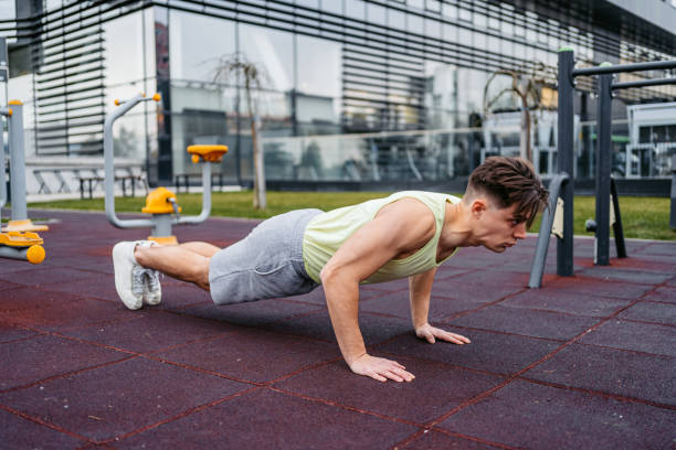 istock Man Doing Push-Ups In An Outdoor Gym 1500405566
