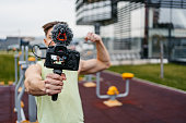 Young Muscular Man Recording Vlog In An Outdoor Gym