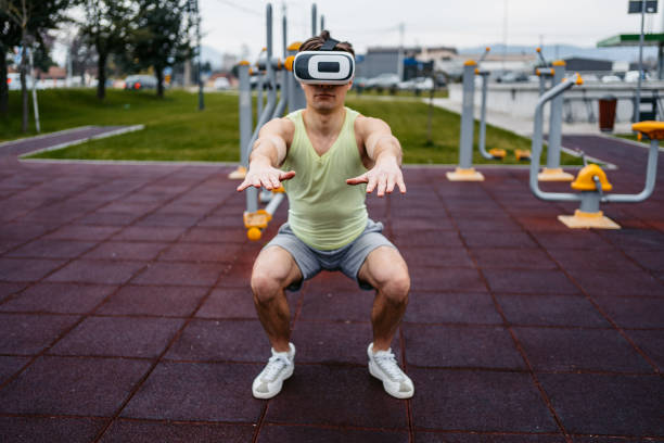 istock Man Wearing Virtual Reality Headset And Doing Squats Outside 1500405936