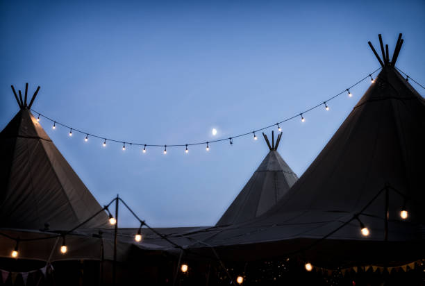 moon behind wedding tipi's decked out with festoon lights - decked imagens e fotografias de stock