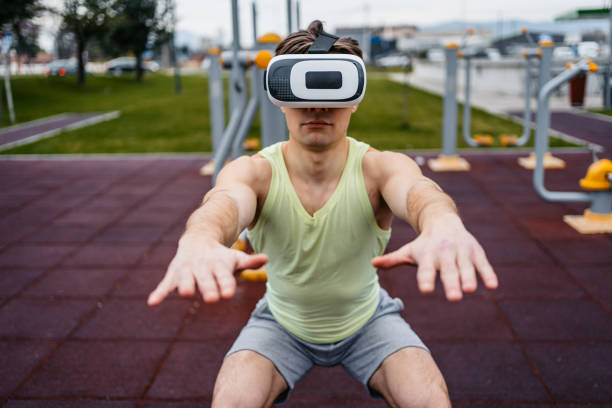 istock Man Wearing Virtual Reality Headset And Doing Squats Outside 1500406074